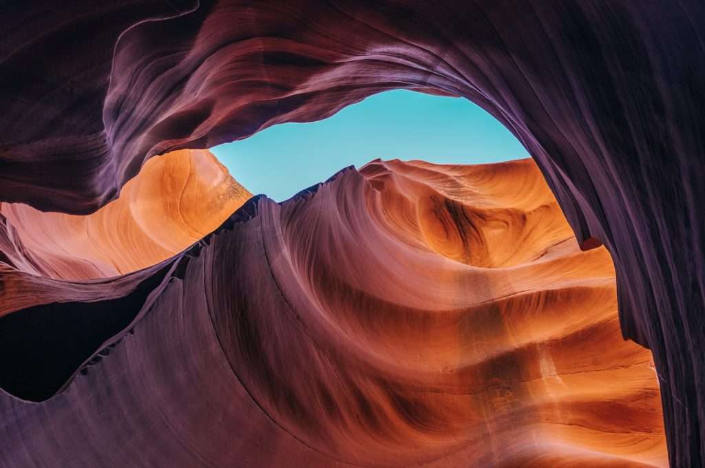 view of turquoise sky through bottom of Antelope Canyon