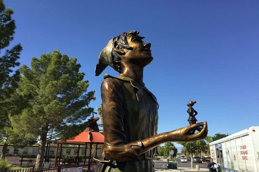bronze statue of Peter Pan and Tinkerbell