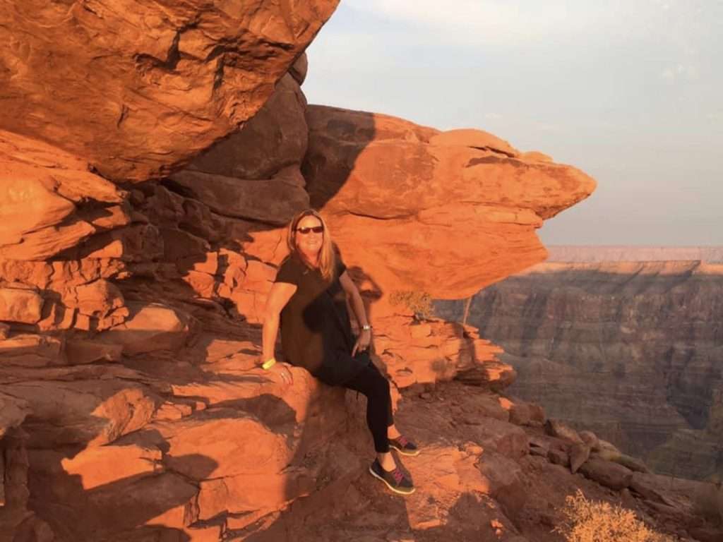 woman sitting on rocky ledge