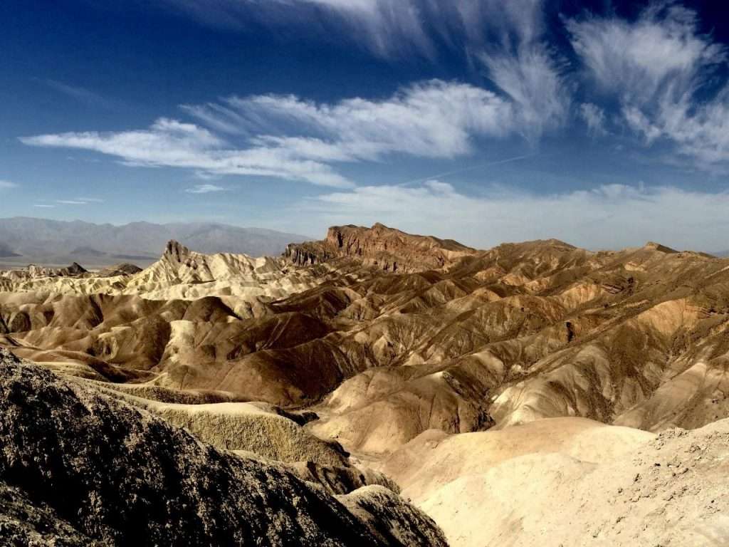 death valley rock formations under clouds