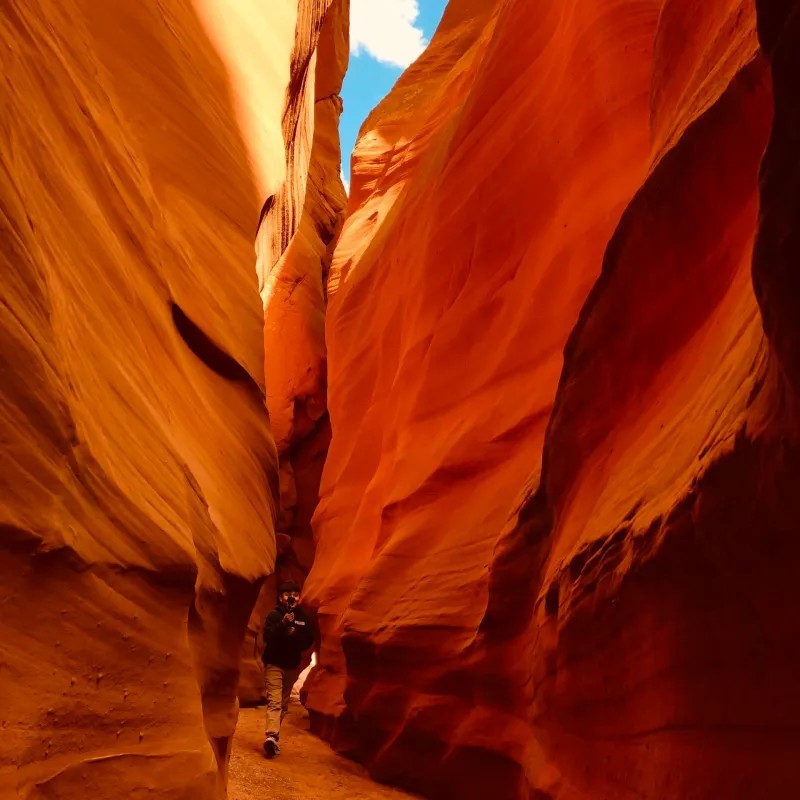 Group tour walking through Antelope Valley Canyon during daytime